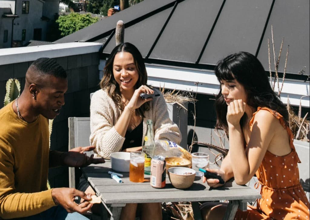 Group of friends socializing together outdoors with PHILTER